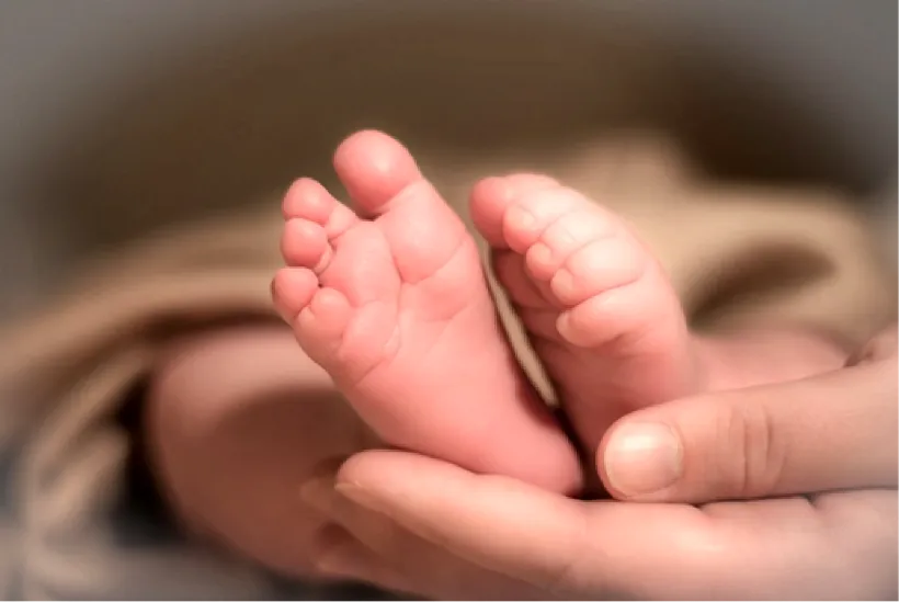 Baby's feet in therapist's hands